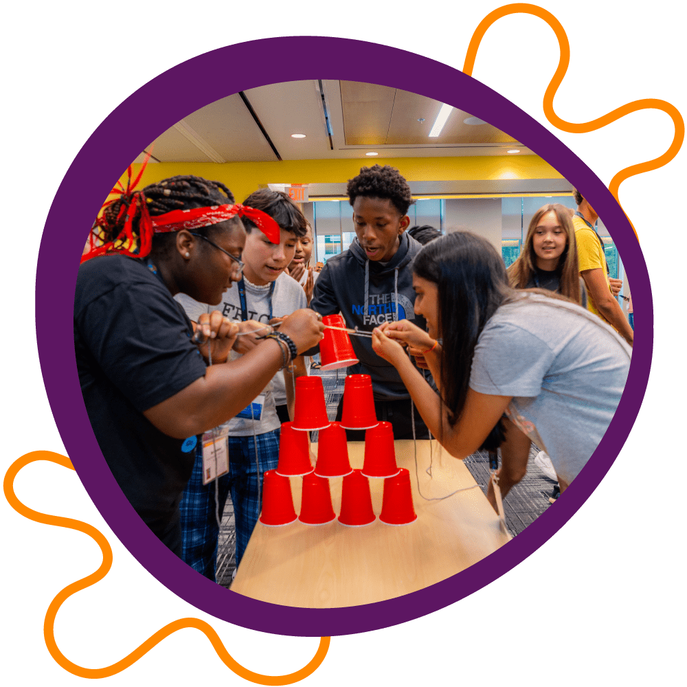 Youth participate in a cup-stacking icebreaker. Youth participate in a cup-stacking icebreaker.